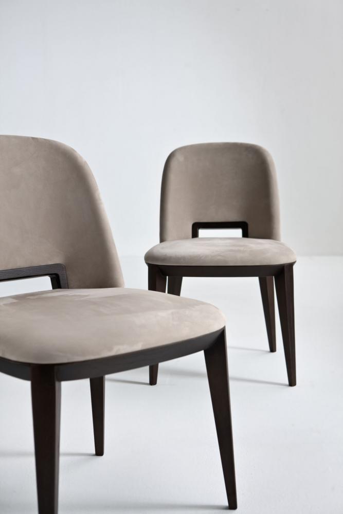 Modern chair in leather velvet or fabric with wooden handle