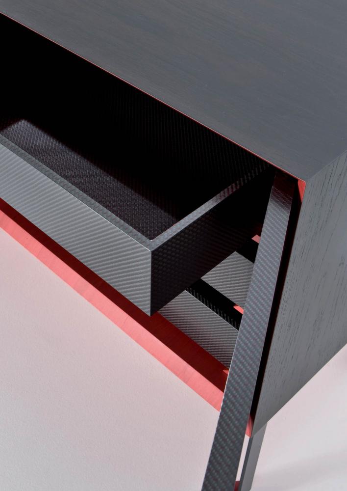 Luxury sideboard designed by Fabrizio Giugiaro handmade in Italy in carbon fiber and StoneOak wood with red frame.