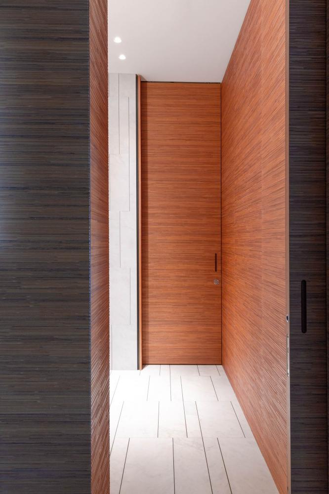 laurameroni decor wall panels and integrated hinged door in textured teak wood