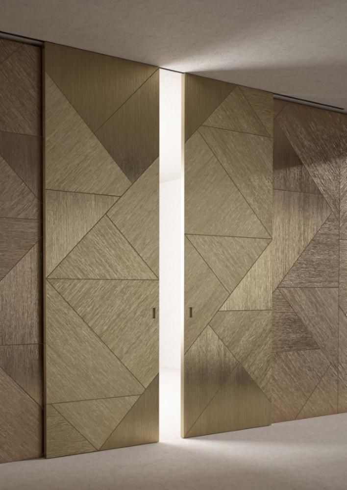 laurameroni integrated sliding door and wall panels in gold wood
