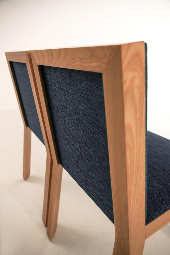 Modern chair with wooden structure covered with fabric or leather