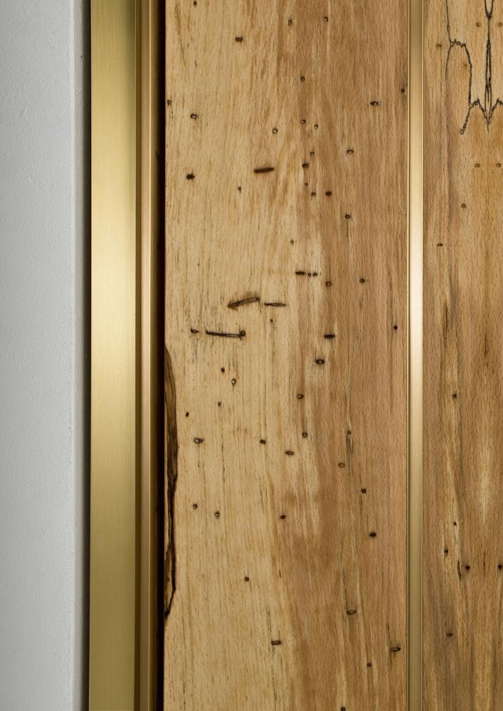 Custom made luxury hinged door in wood with brass profiles